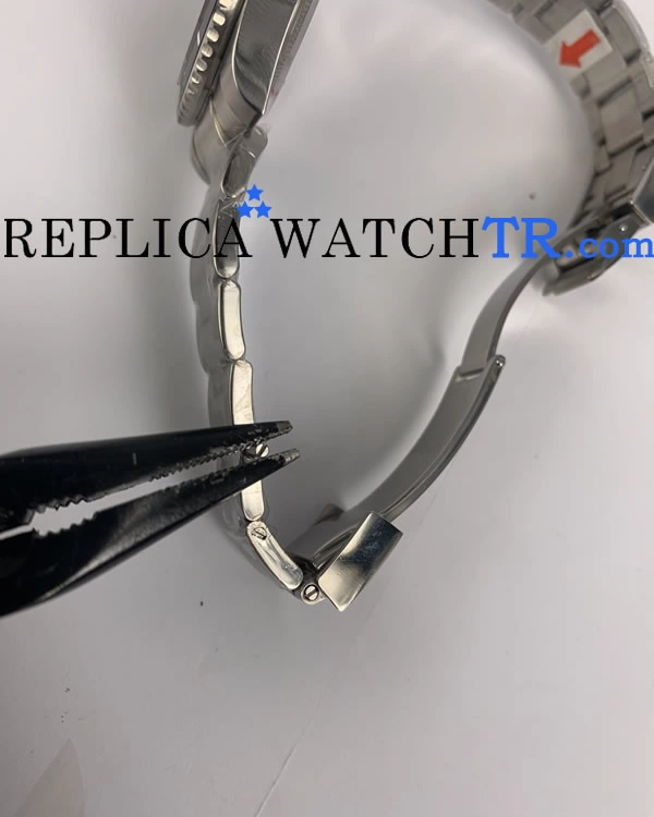 Final step in adjusting replica Rolex watch